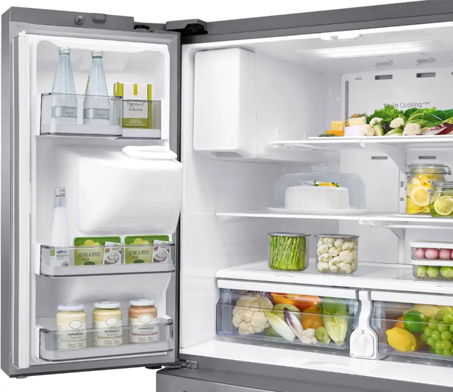 The image shows a refrigerator with its door open, revealing a variety of food items stored inside. The refrigerator is filled with different types of food, including yogurt, frozen items, and other perishable goods. The refrigerator is well-stocked, indicating that the owner is well-prepared for meals and snacks.