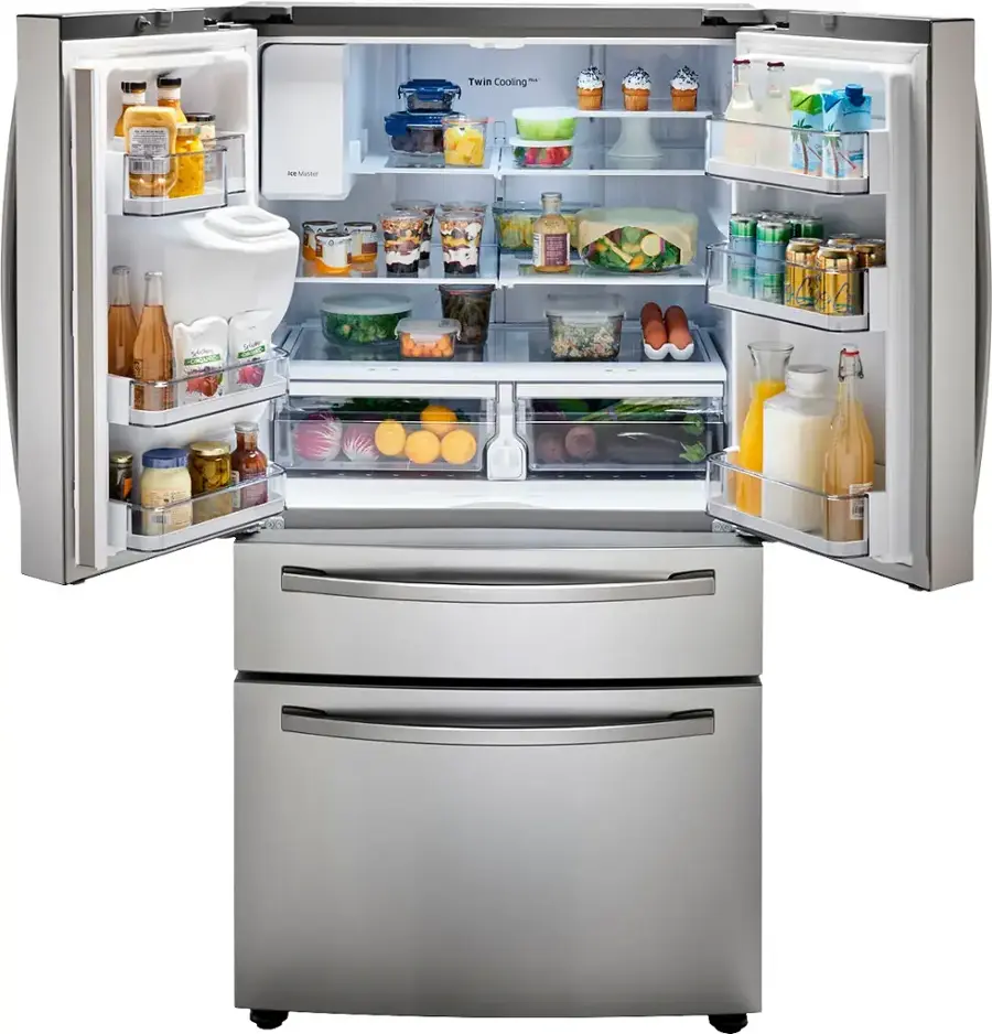 The image shows a large, silver, two-door refrigerator with its doors open, revealing a well-stocked interior. The refrigerator is filled with various food items, including multiple bottles, oranges, and broccoli. The bottles are located in different sections of the refrigerator, with some placed on the upper shelves and others on the lower shelves. The oranges are placed in the middle of the refrigerator, while the broccoli is located towards the bottom right side. The refrigerator appears to be a full-size model, providing ample storage space for a family's groceries.