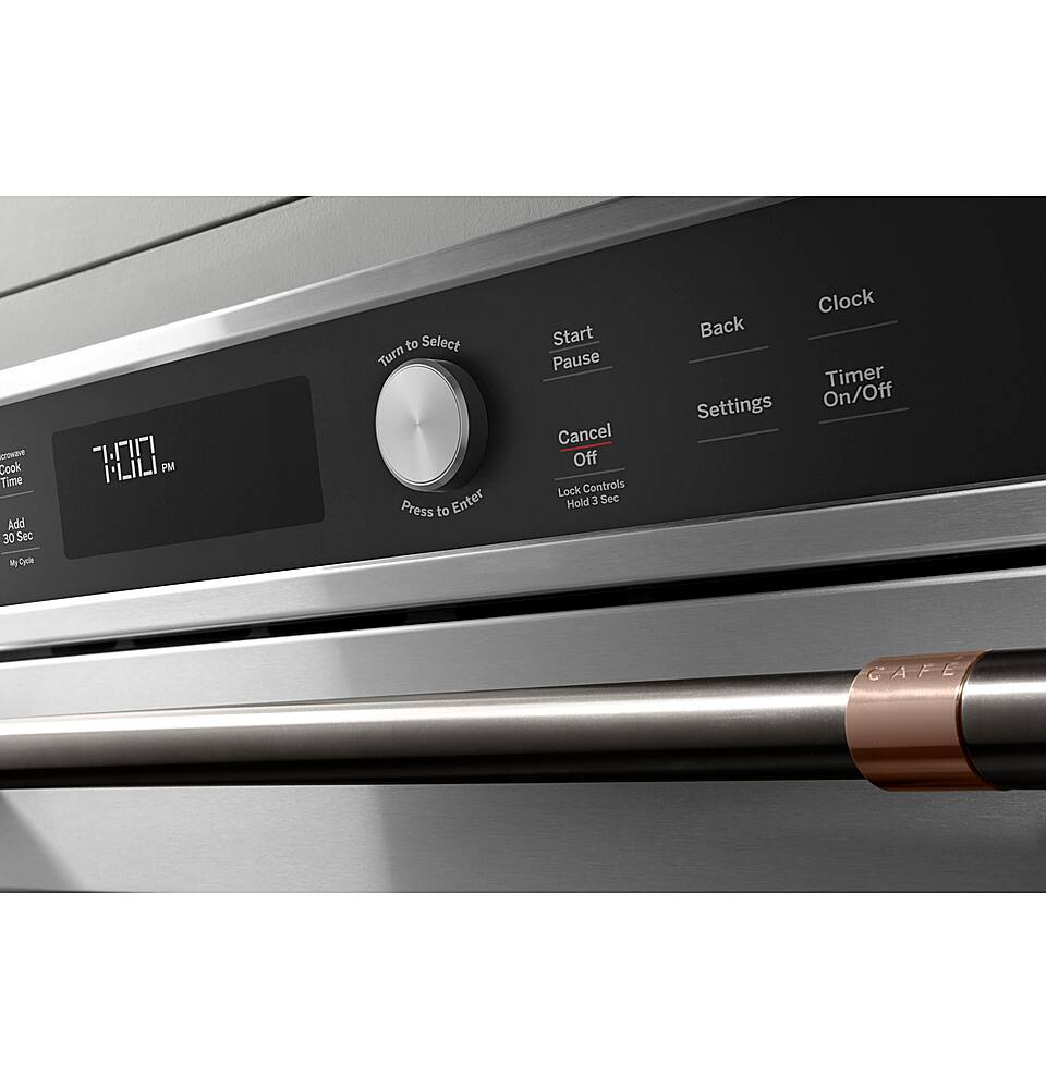 The image features a stainless steel oven with a digital clock on the front. The clock shows the time as 7:00. The oven has a timer and various settings, including "Start," "Pause," "Cancel," "Off," "Lock," and "Back." The oven also has a "Hold 3 Sec" feature, which allows the user to pause the timer for three seconds. The oven's control panel is clean and well-organized, making it easy to navigate and use.