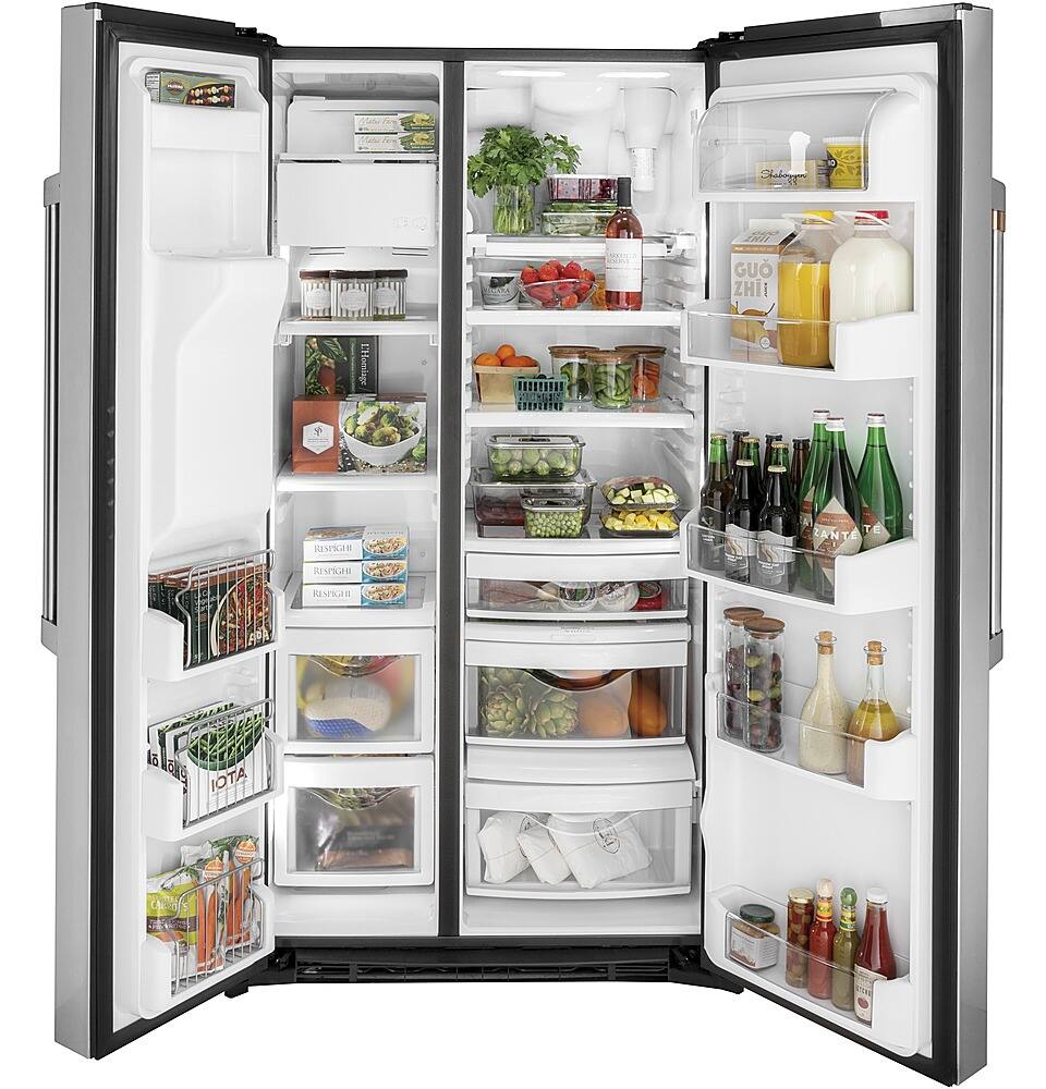 The image shows a refrigerator with its door open, revealing a well-stocked interior. The fridge is filled with various food items, including several bottles, fruits, vegetables, and a bowl. The bottles are scattered throughout the refrigerator, with some placed on the top shelves and others on the middle and bottom shelves. The fruits and vegetables are organized in different compartments, with some placed in the crisper drawers and others on the shelves. The bowl is located on one of the shelves, possibly containing a prepared meal or ingredients for cooking. The refrigerator is fully stocked, indicating that the owner is well-prepared for meal planning and cooking.