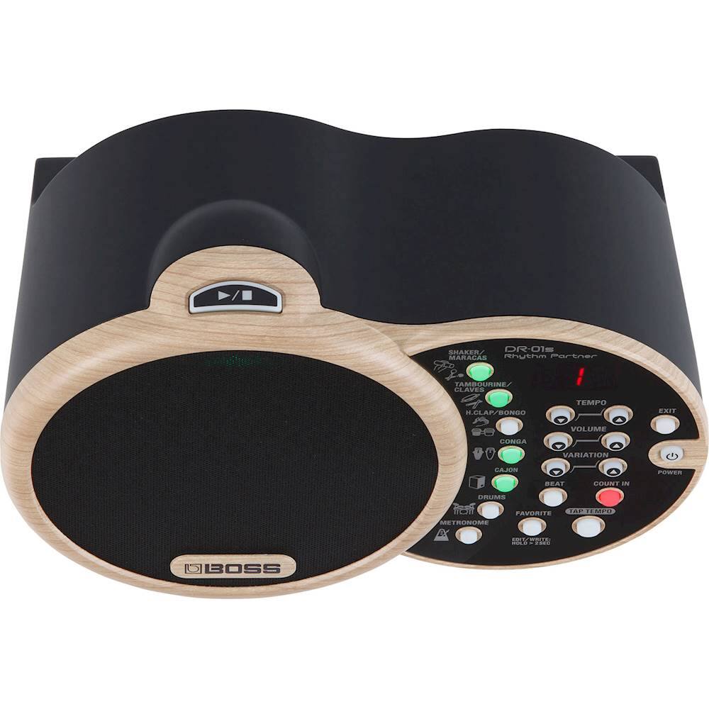 The image features a Boss brand drum machine, which includes a shaker, maracas, and claves. The drum machine also has a tempo exit, volume control, and a metronome function. The device is designed to provide rhythm and percussion accompaniment for various musical genres.