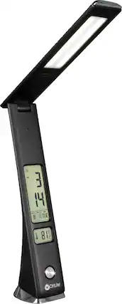 The image features a black and silver clock with a digital display. The clock is set to 3:14, and it is positioned on a stand. The stand is designed to provide a light source, making it a multi-functional device. The clock is likely used for timekeeping and providing a source of light in a room.
