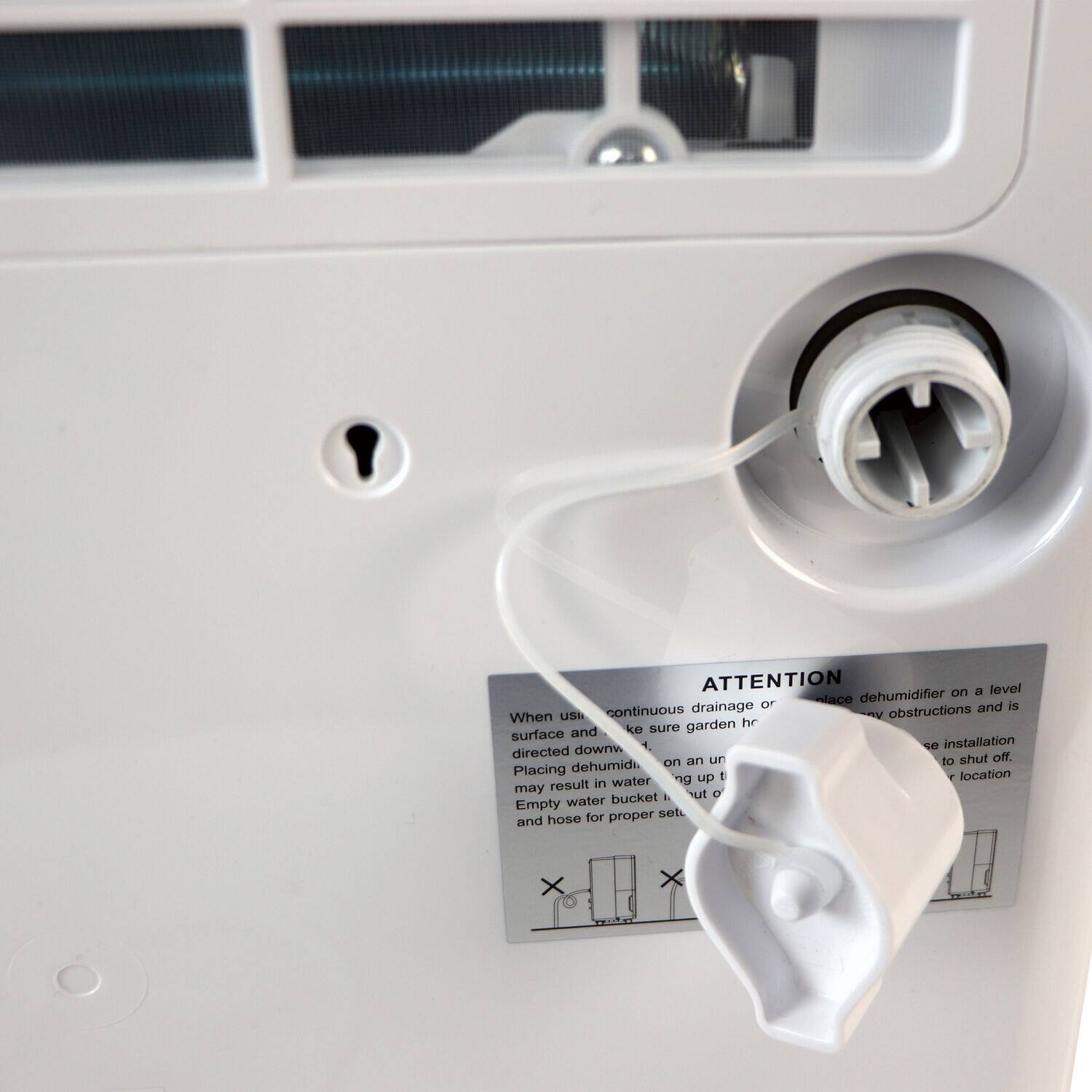 Attention: On a level surface, dehumidifier drainage hose should be placed to ensure proper drainage and prevent obstructions. Installation should be directed according to the manufacturer's instructions. Placing the dehumidifier on an uneven surface may result in water spilling out of the water bucket. Empty the water bucket regularly to prevent water damage and maintain proper performance.