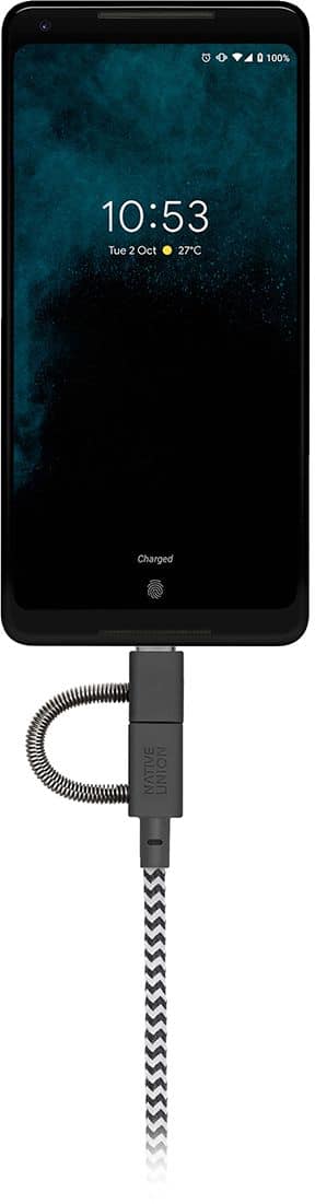 The image shows a cell phone being charged with a cable. The phone is displaying the time of 10:53.