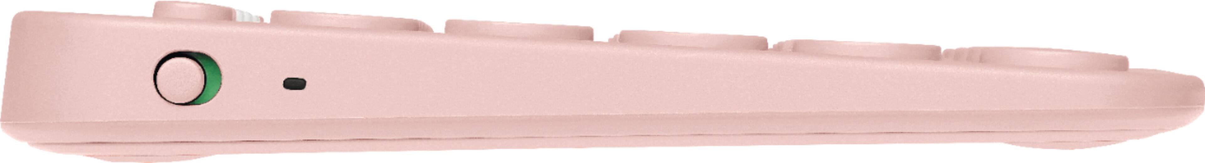 The image shows a pink Logitech keyboard with a variety of buttons, including letters, numbers, and function keys. The keyboard has a distinctive pink color and is designed for easy use. The layout of the keyboard includes the numbers 1 through 9, as well as letters A through Z, and function keys such as F1 through F8. The keyboard also features a dedicated key for the Esc (Escape) function, which is often used to cancel or undo actions in various software applications.