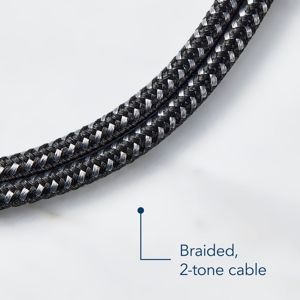 The image features a close-up view of a braided, 2-tone cable. The cable is made up of multiple strands, creating a unique and eye-catching pattern. The two-tone color scheme adds a touch of style and sophistication to the cable, making it an attractive choice for various applications. The close-up view of the cable highlights its intricate design and texture, showcasing the craftsmanship that goes into creating such a cable.