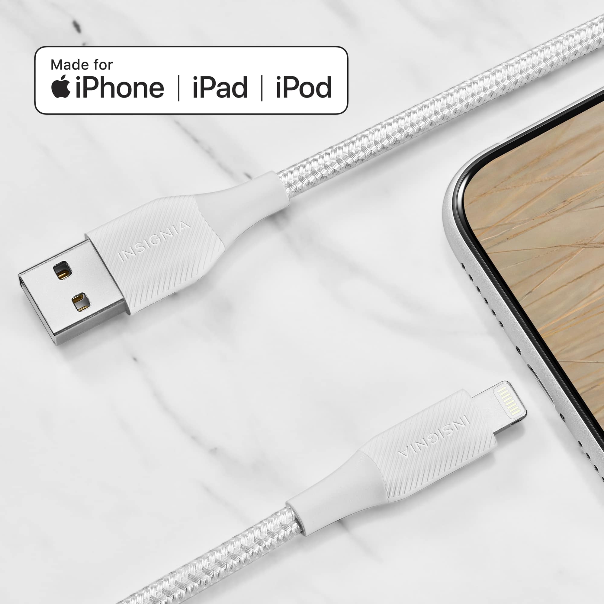 The image features a white iPhone connected to a white charger. The charger is plugged into the iPhone, and the device is sitting on a marble table. The charger is made for iPhone, iPad, and iPod, ensuring compatibility with various Apple devices.