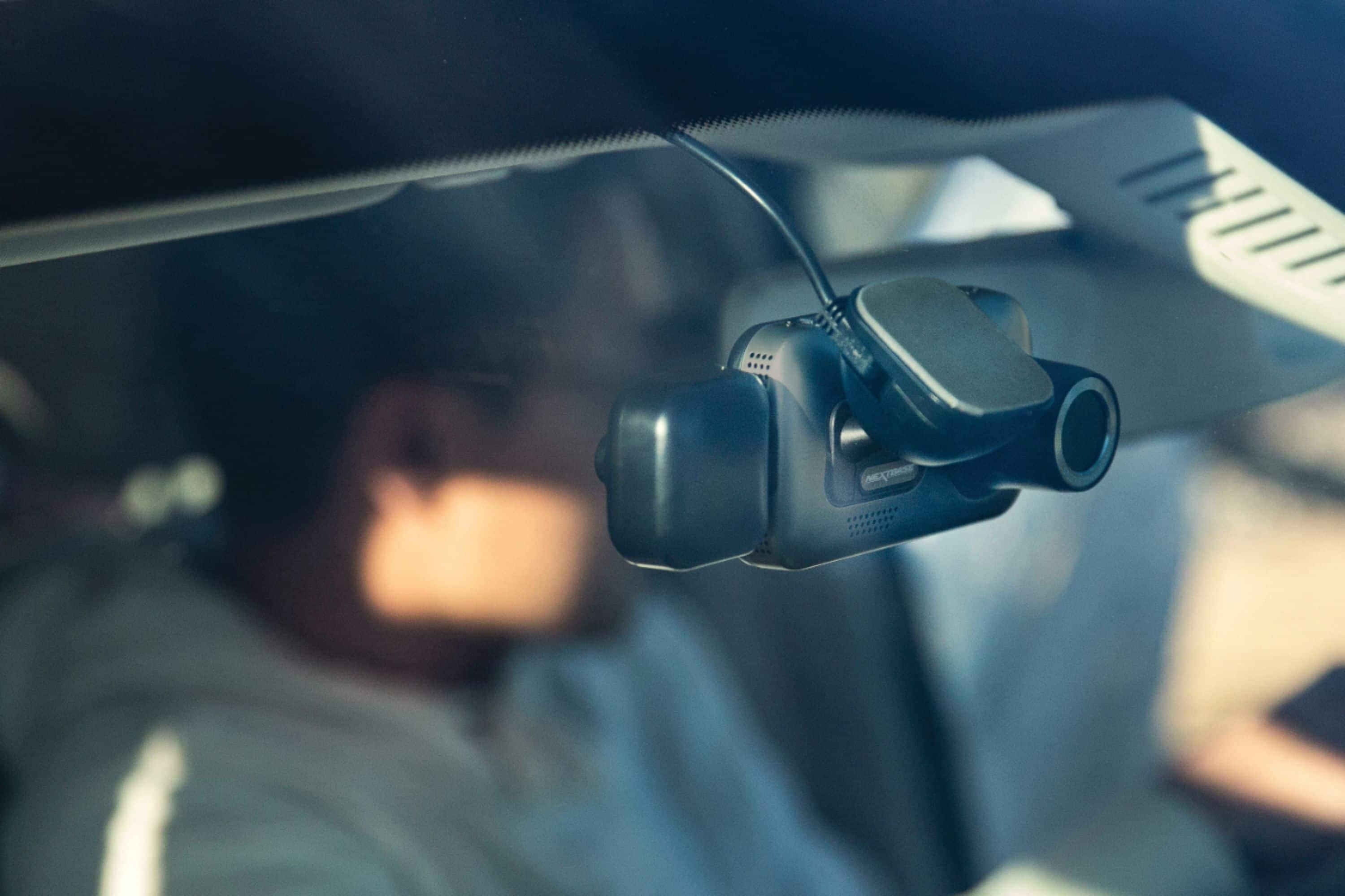 A car dashboard with a camera mounted on it.