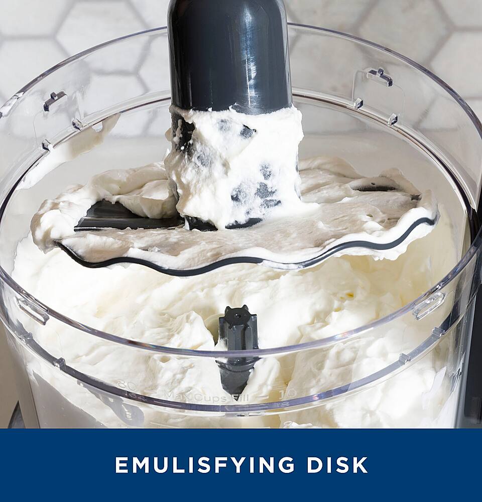 The image features a large mixing bowl filled with whipped cream. The bowl is placed on a countertop, and there is a mixer inside the bowl, which is likely responsible for creating the whipped cream. The bowl is filled with a substantial amount of whipped cream, making it an emulsifying disk.