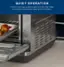 The image features an air fryer with a tray of food inside, placed on a counter. The air fryer is designed with a silent motor and fan, ensuring a peaceful cooking environment. The focus of the image is on the quiet operation of the air fryer, making it an ideal choice for those who want to avoid loud noises while cooking.