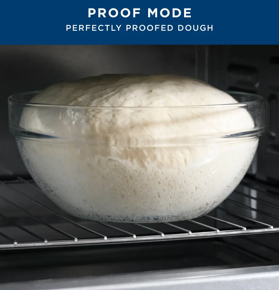 The image shows a large bowl filled with dough, placed inside an oven. The dough appears to be perfectly proofed, indicating that it has been prepared using the proof mode. The proof mode is a technique used to achieve the desired texture and rise in yeast-based doughs, such as bread or pizza dough. The oven's interior is visible, and the dough is placed on a rack, allowing it to rise evenly and achieve the desired texture.