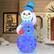 Left. Novelty Lights - 7’ Inflatable Swirling Lights Snowman with tipping Hat - White.