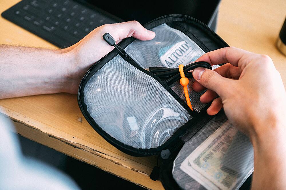 A person is holding a small bag of Altoids in their hand.
