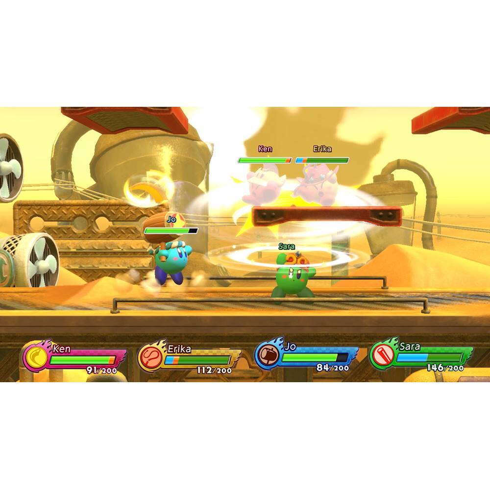 The image shows a video game with two characters, Ken and Jo, engaged in a battle. Ken is on the left side of the image, while Jo is on the right side. The game appears to be a boxing match, with both characters throwing punches at each other. The game is set in a desert environment, with sand and a backdrop of a sandstorm. The characters are positioned in front of a large machine, which adds to the overall atmosphere of the game.