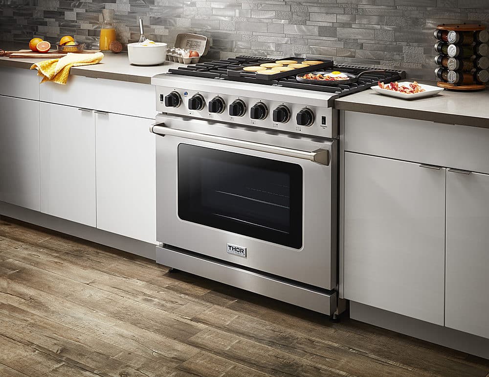 Left. Thor Kitchen - 6.0 cu. ft. Freestanding Gas Convection Range with Storage - Stainless Steel.