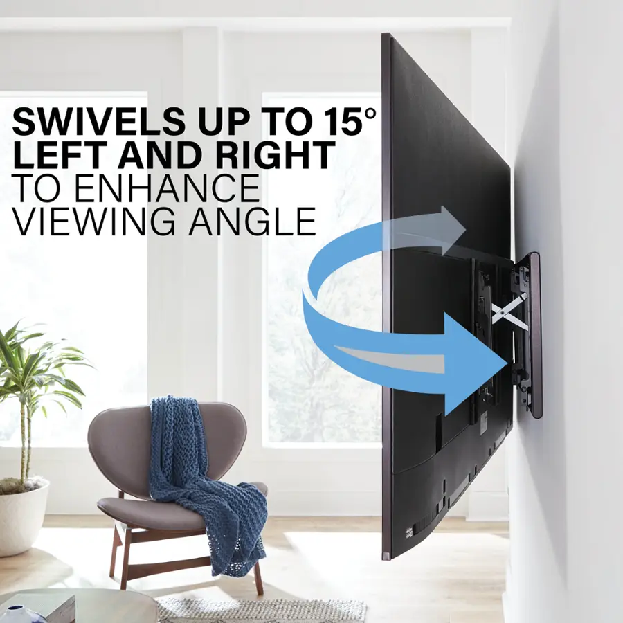 The image features a large flat screen TV mounted on the wall. The TV is designed to swivel up to 15 degrees to the left and right to enhance the viewing angle. The TV is positioned in a living room, with a chair nearby. The room also contains a potted plant, adding a touch of greenery to the space.
