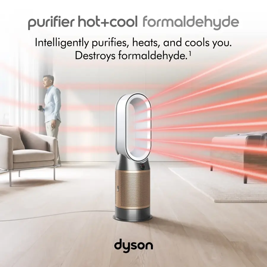 The image features a purifier hot+cool formaldehyde device from Dyson, which is designed to intelligently purify, heat, and cool its user. The device is placed on a wooden floor, and there is a man standing in the background. The purifier is surrounded by a few chairs, and a couch is also visible in the scene. The image emphasizes the benefits of using this device, as it destroys formaldehyde, providing a healthier and more comfortable environment for its user.