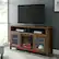 Alt View 13. Walker Edison - 58" Tall Glass Two Door Soundbar Storage Fireplace TV Stand for Most TVs Up to 65" - Rustic Oak.