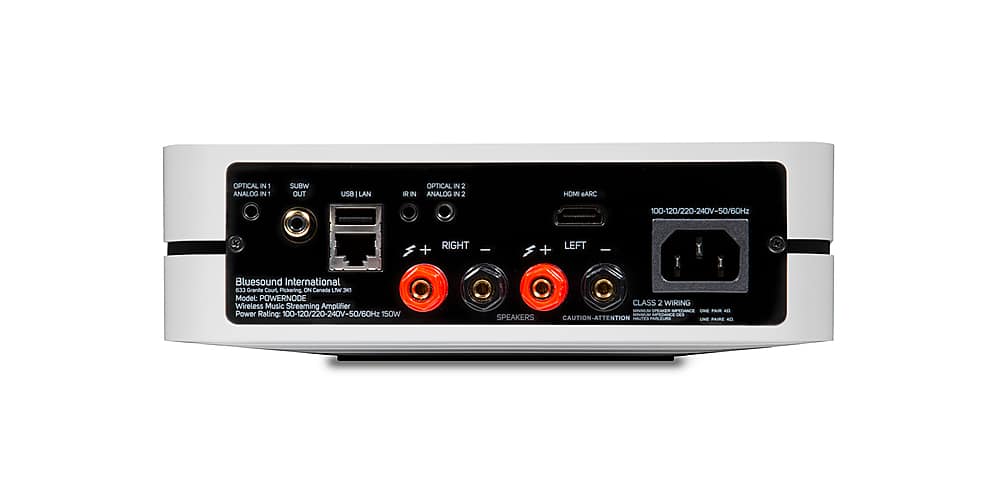 The text on the image reads: "OPTICAL IN 1 ANALOG IN 1 SUBW OUT USe - LAN R IN OPTICAL IN 2 ANALOG IN 2 HOM eARC 100-120/220-240V-50/6OHz x RIGHT + - + LEFT - Bluesound International 633 Granita Court Pickering ON Canade Lfw DEE Model: POWERNODE Wireless Music Streaming Amplifier Power Rating: 100-120/220-240V-50/6OHz 150W CLASS 2 WIRING - SPEAES DES SPEAKERS CAUTION-ATTENTION."