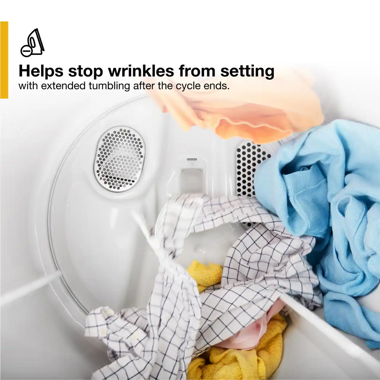The image shows a washing machine with a pile of clothes inside it. The machine is filled with clothes, and some of them are hanging out of the machine. The clothes are in various stages of being washed, and the machine is likely in the process of tumbling after the cycle ends. This helps to stop wrinkles from setting, ensuring that the clothes come out looking fresh and wrinkle-free.