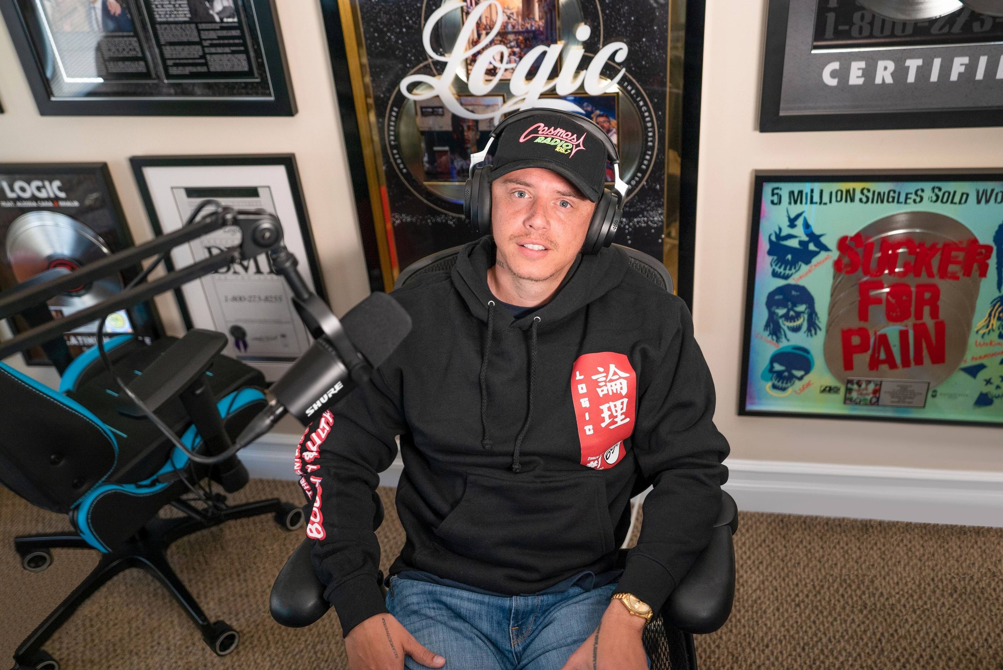 The text on the image reads: "Logic Dr. Dre Beats by Dr. Dre. Logic TWE.INCHEDIBLE Carbon Fiber Radio. Shure MV7. 1-800-45-CERTIFIED 5 MILLION SINGLES SOLD. Sucker for Pain."