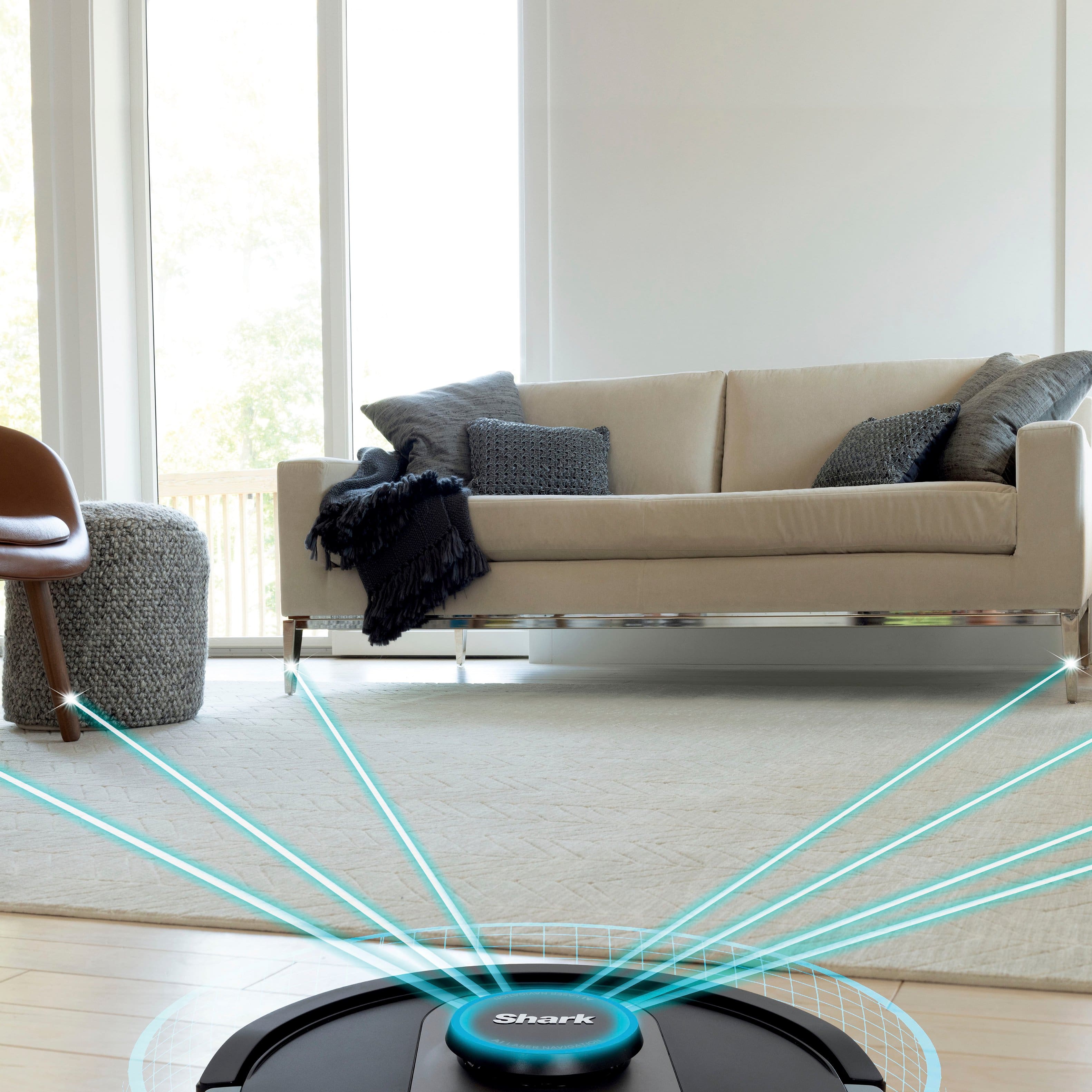 The image features a robot vacuum cleaner that is designed to detect and avoid objects. It is placed on a carpeted floor with a chair nearby. The robot vacuum cleaner is equipped with a sensor that helps it navigate around objects, making it a convenient and efficient cleaning tool. The advertisement emphasizes that there is no need to pick up objects before the robot cleans, as it can detect and avoid objects that are 4.5 inches or greater in its path. This feature allows for a more hassle-free cleaning experience.