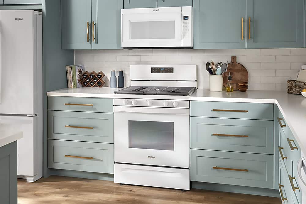 The text on the image reads "Sorpia Whirgbol een OPEN KITC M D A S - e 20 Whatbo." However, this text does not seem to be related to the image of the kitchen. The image features a kitchen with a white refrigerator, a microwave, a stove, and cabinets. There are also several books and knives on the countertop.