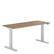 Angle. Steelcase - Migration SE Adjustable Height Standing Desk - Virginia Walnut.