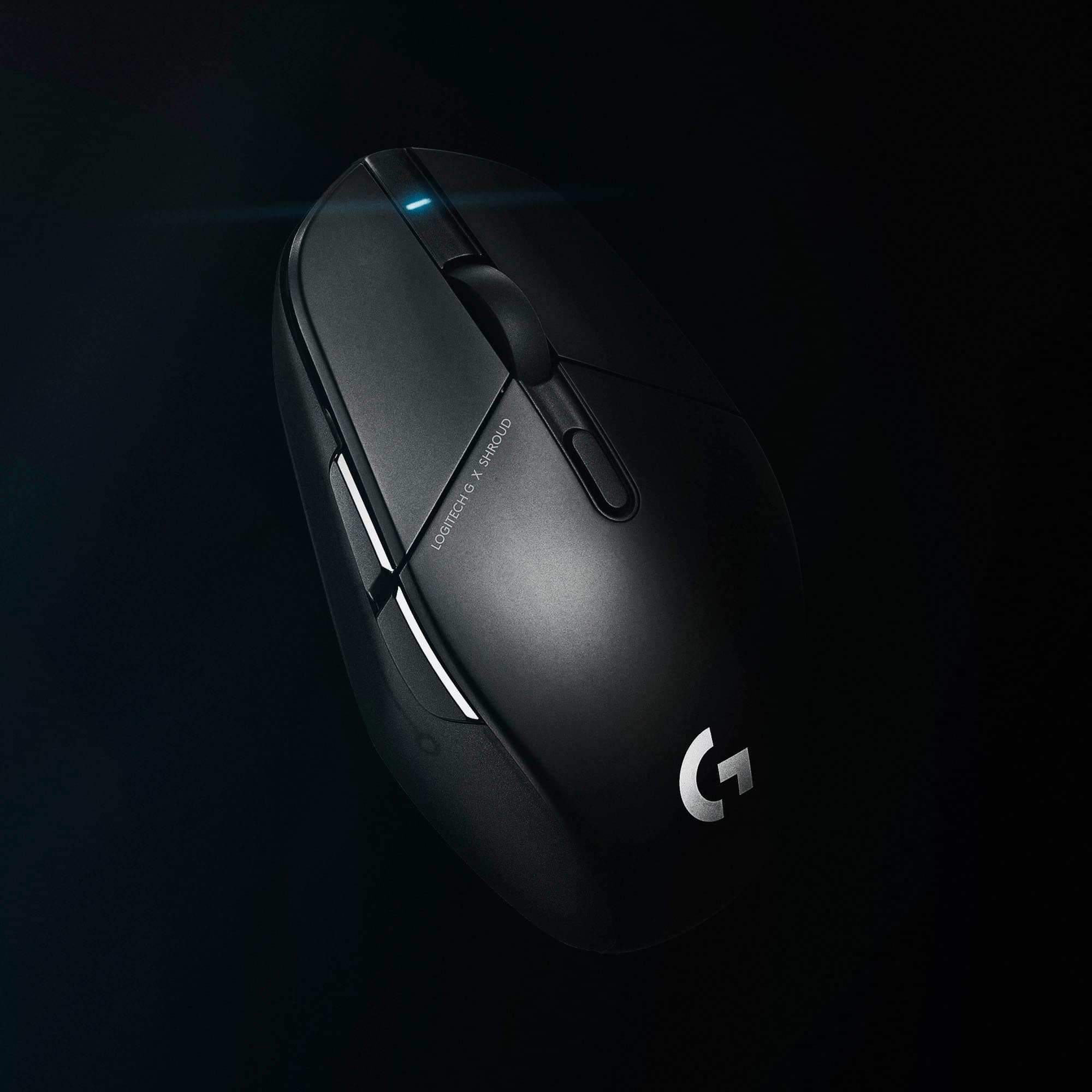 The image shows a black computer mouse with a G logo on it. The mouse is positioned on a black background, and the G logo is prominently displayed on the mouse. The mouse is designed by Logitech, and it is likely intended for use with a computer or other electronic devices.