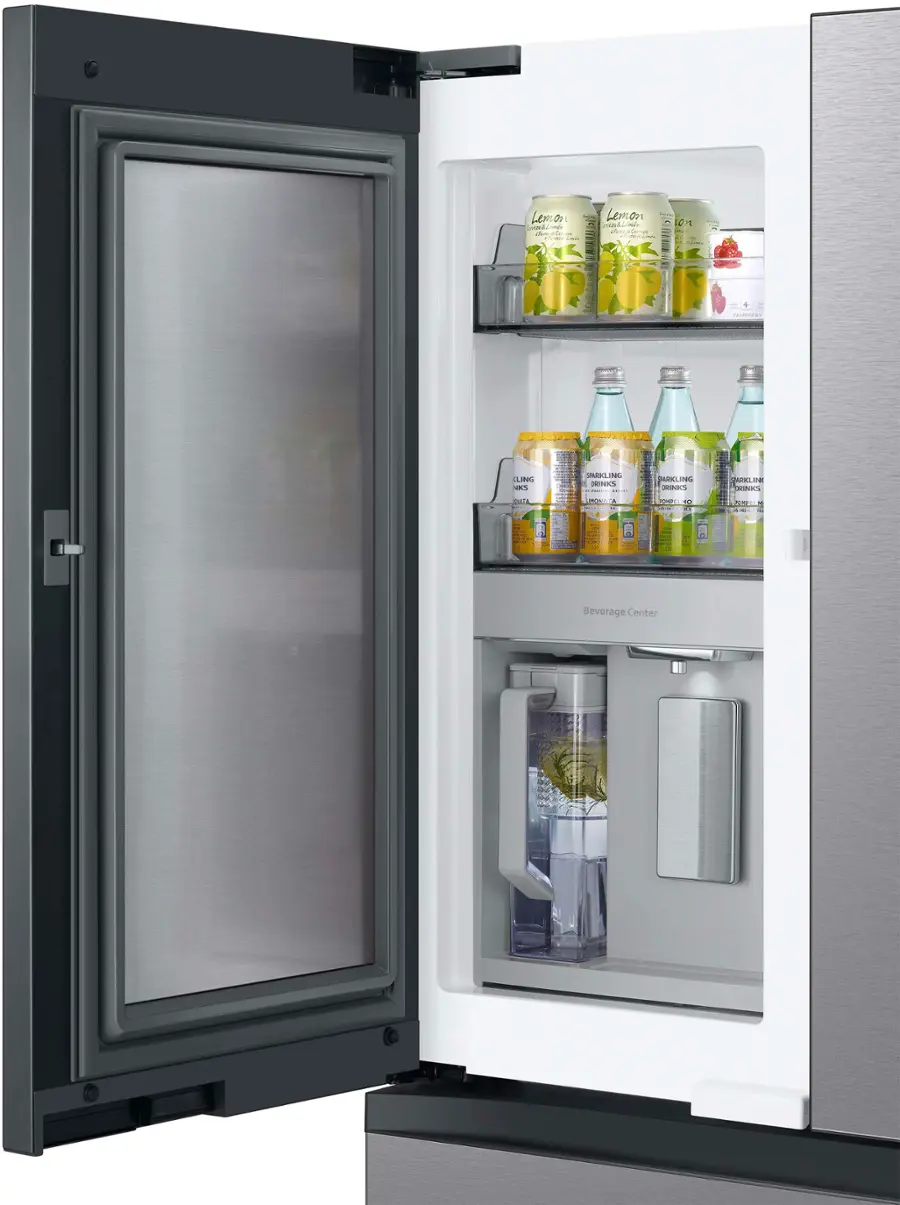 The image shows a refrigerator with its door open, revealing a variety of drinks inside. There are several bottles of water and juice, as well as a few cans of soda. The refrigerator is well-stocked, providing a range of beverage options for those who use it.