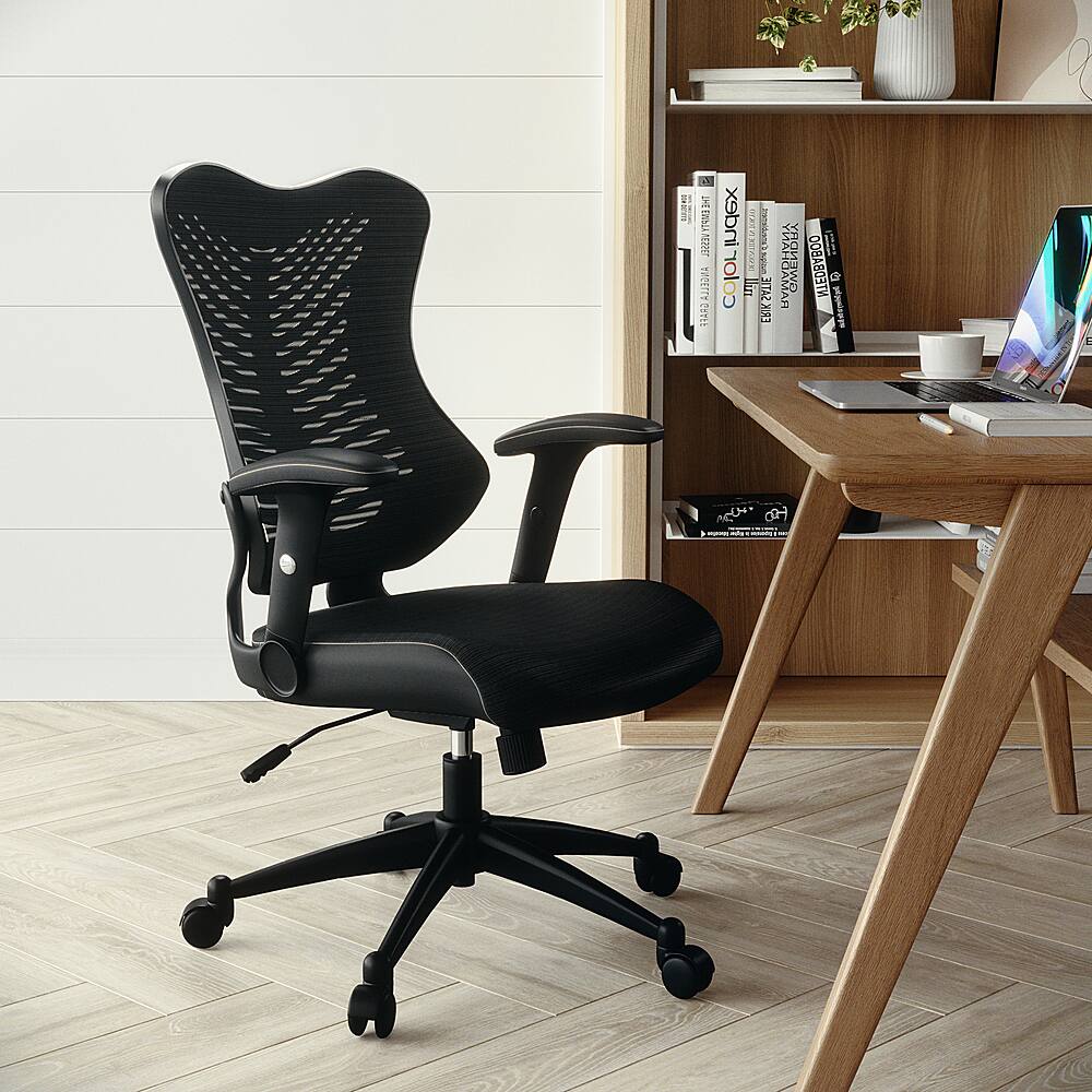 The image features a black office chair positioned in front of a wooden desk. The desk is equipped with a laptop and several books, creating a workspace. The chair is placed on a hardwood floor, and there is a potted plant nearby, adding a touch of greenery to the room.