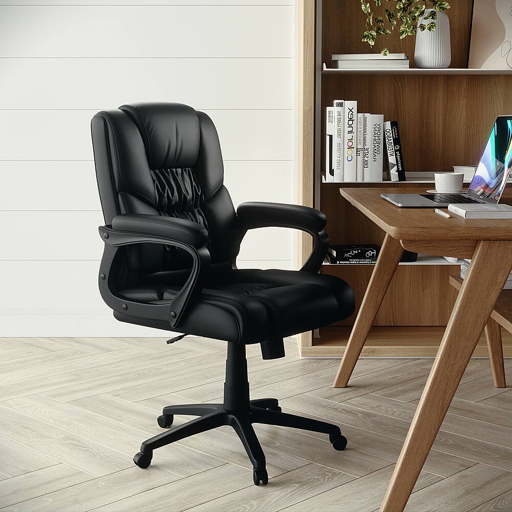 The image features a black office chair positioned in front of a wooden desk. The desk has a laptop and a keyboard on it, and there are several books scattered around the area. Additionally, there is a potted plant placed nearby, adding a touch of greenery to the space. The overall scene suggests a workspace or a home office setup.