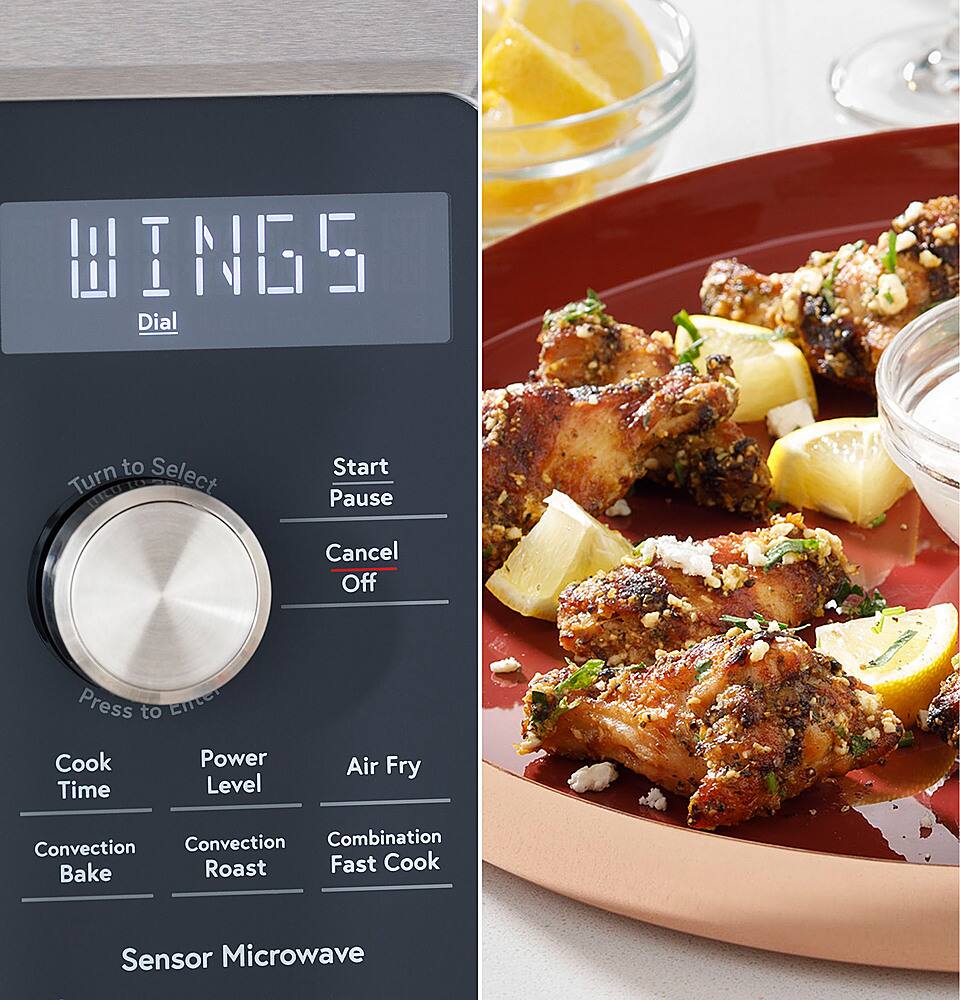 The image features a microwave oven with a plate of food, specifically chicken wings, on top of it. The microwave has a digital display that reads "Wings" and a button labeled "Dial to Select." The chicken wings are placed on a red plate, and there is a bowl nearby. The image also includes a wine glass and a lemon, adding to the overall presentation of the scene.