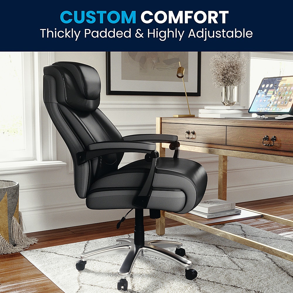 The image features a black office chair with a thickly padded seat and a highly adjustable design. The chair is placed on a wooden floor, and there is a laptop on a desk nearby. The chair is positioned in front of a window, providing a comfortable and ergonomic workspace.