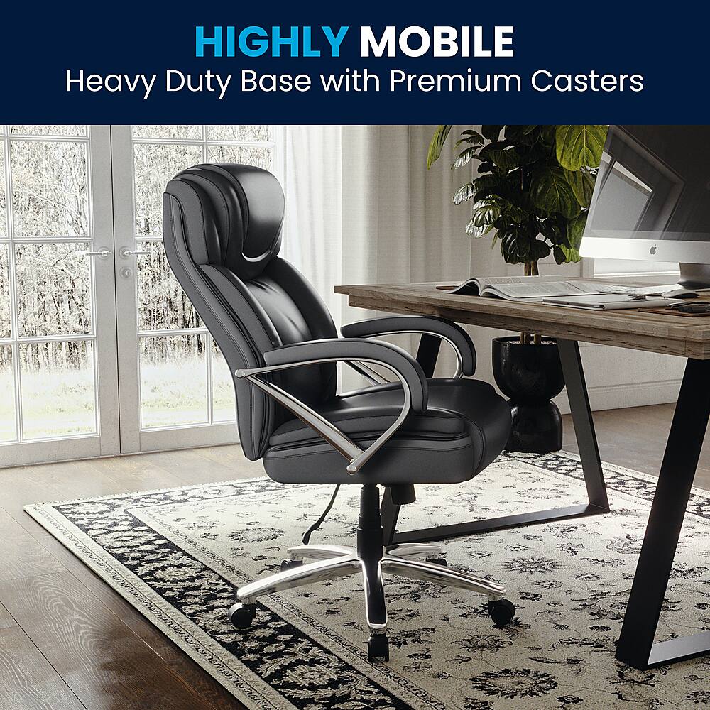 The image features a black office chair with a heavy duty base and premium casters. The chair is placed on a rug, and there is a desk with a laptop and a potted plant nearby. The scene suggests that the chair is highly mobile and designed for easy movement, making it a convenient choice for a busy workspace.