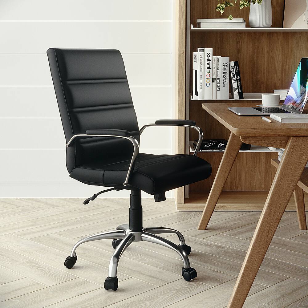The image features a black office chair with wheels, positioned in front of a wooden desk. The desk is equipped with a laptop, a keyboard, and a mouse. There are also several books placed on the desk, and a cup can be seen nearby. The scene appears to be a workspace or home office setup.