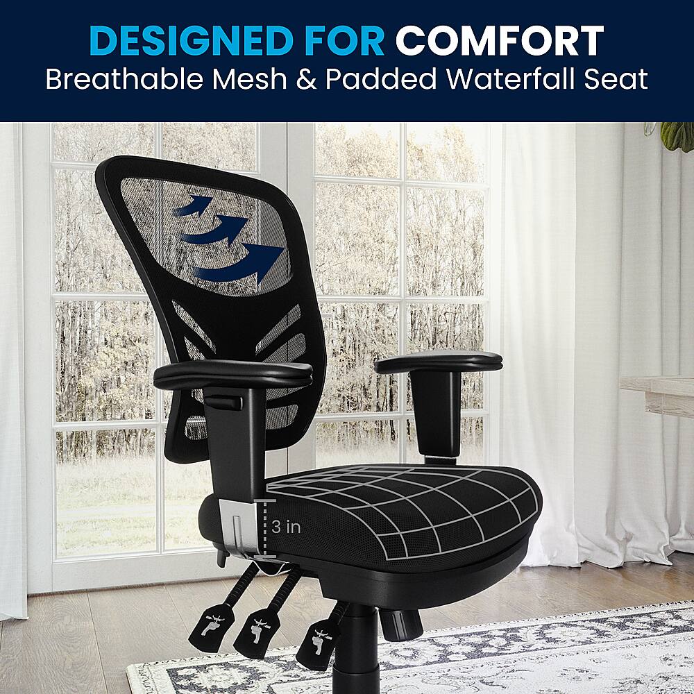 Designed for comfort, the black chair features a breathable mesh and padded waterfall seat, providing both support and comfort for the user. The chair is placed in a room with a window, allowing natural light to illuminate the space.