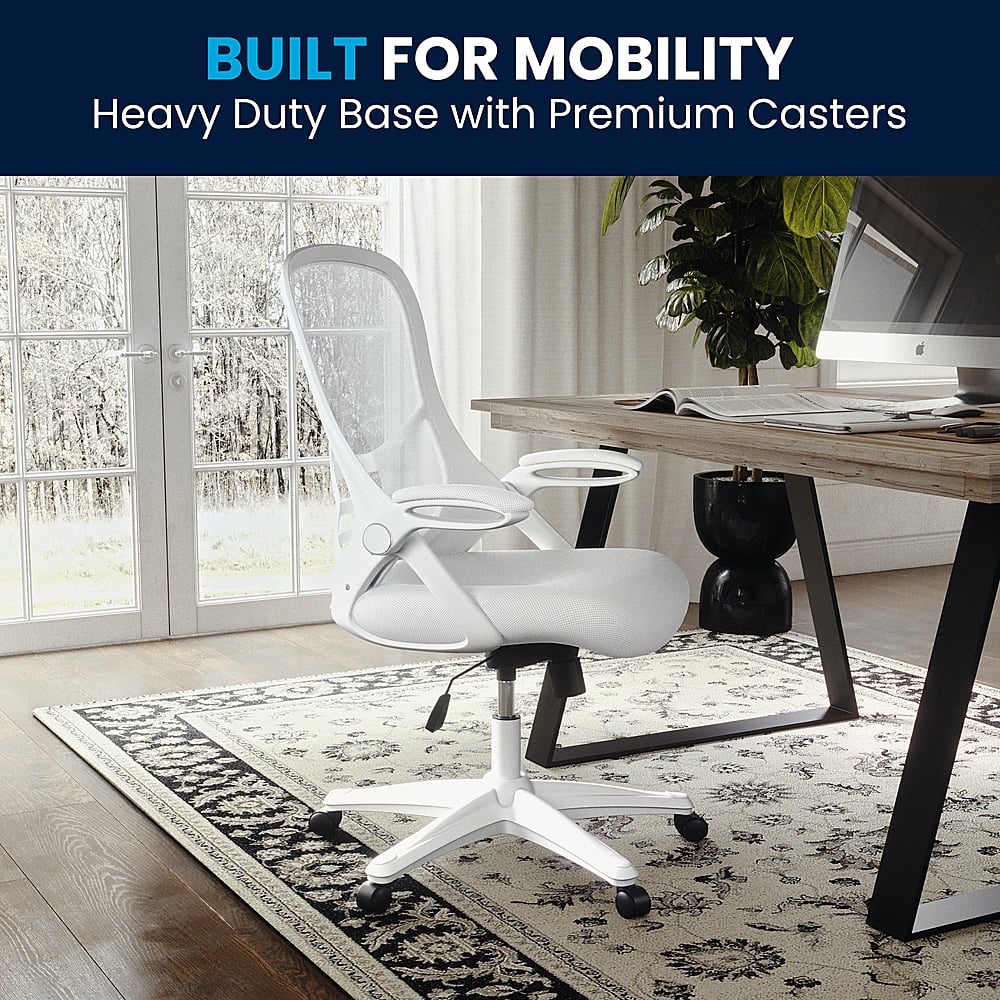 The image showcases a white office chair placed on a rug in front of a desk. The chair is designed for mobility, featuring a heavy-duty base with premium casters for easy maneuvering. The desk is accompanied by a laptop, keyboard, and mouse, creating a comfortable workspace. Additionally, there is a potted plant nearby, adding a touch of greenery to the room.