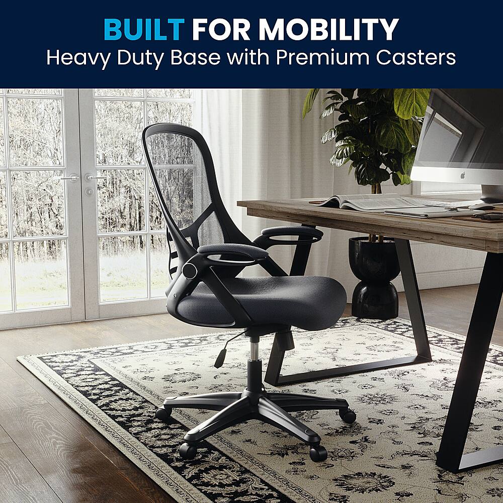 The image showcases a black office chair with a heavy duty base and premium casters, placed on a rug in front of a wooden desk. The chair is designed for mobility and is suitable for use in various settings, such as offices, homes, or conference rooms. The desk is equipped with a computer, keyboard, and mouse, making it a functional workspace. The combination of the chair and desk creates an ergonomic and comfortable environment for work or study.