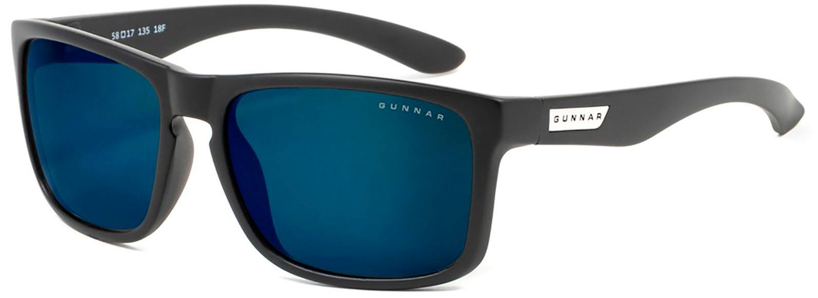 The image features a pair of Gunnar sunglasses with blue lenses. The sunglasses are designed to protect the eyes from harmful UV rays and provide comfort during outdoor activities. The blue lenses are likely intended to enhance contrast and reduce glare, making it easier to see in various lighting conditions. The sunglasses are placed on a white background, which highlights their design and color.