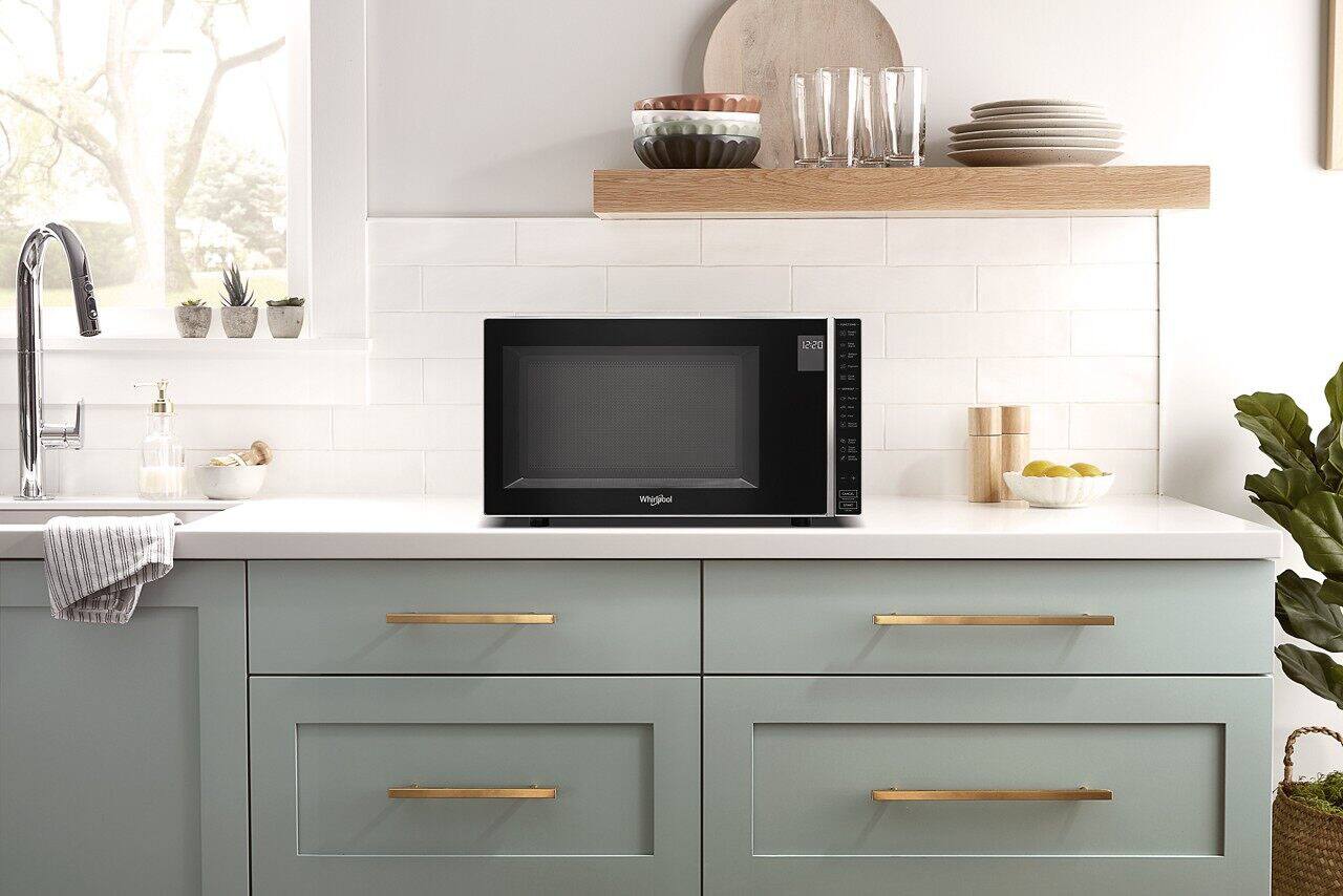 The text on the image reads: "1.1 CU. FT. 900 Watts 12:20 Add 30 Seconds Option Whirlpool Keep Warm."