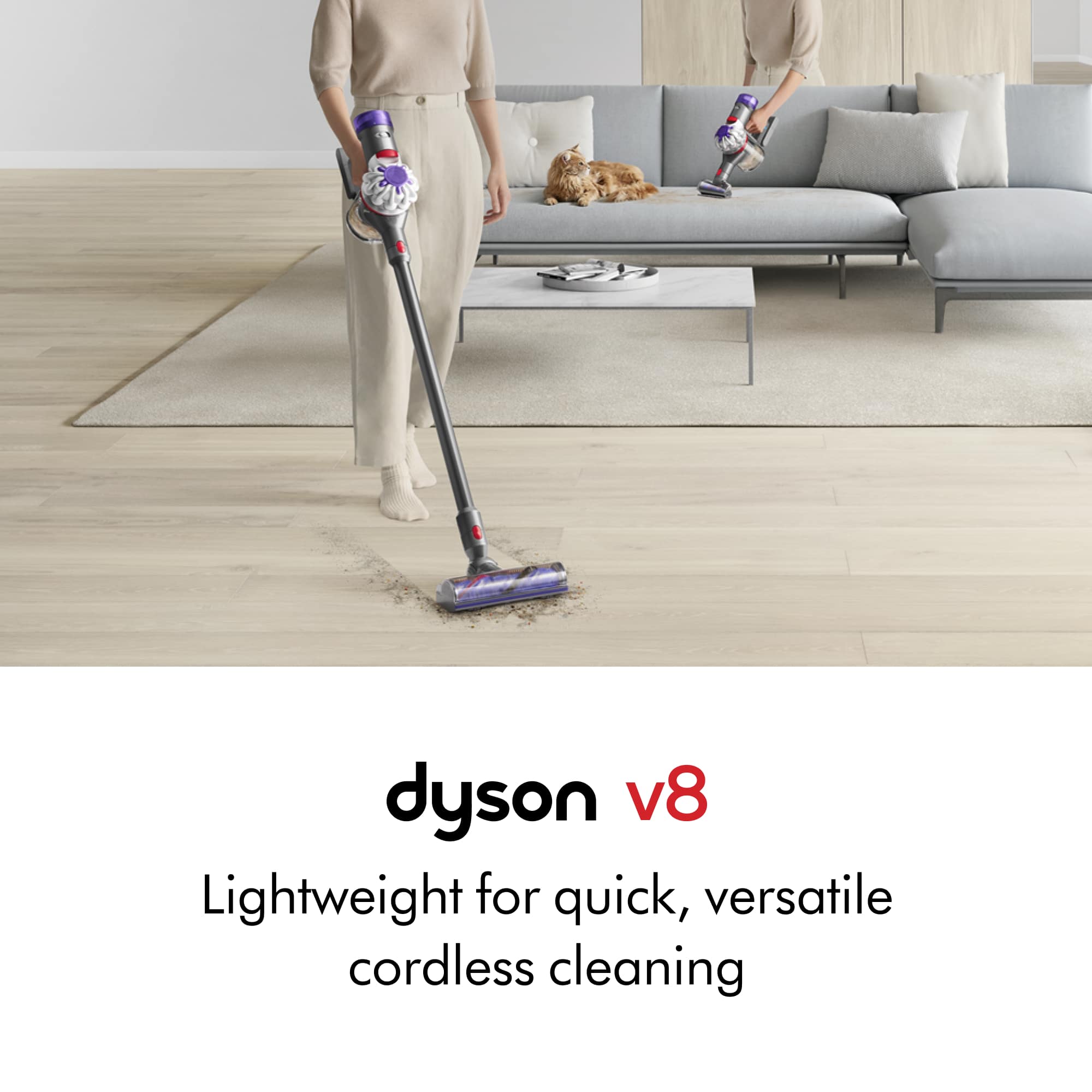 The image features a woman standing in a living room, holding a Dyson V8 vacuum cleaner. She is vacuuming the floor, with a couch in the background. The Dyson V8 is a lightweight, versatile, and cordless cleaning device that provides quick and efficient cleaning.