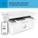 The image features a white HP printer with a cell phone placed next to it. The printer is wireless and has a self-reset function to help stay connected. The cell phone is likely used for printing purposes or to control the printer remotely.