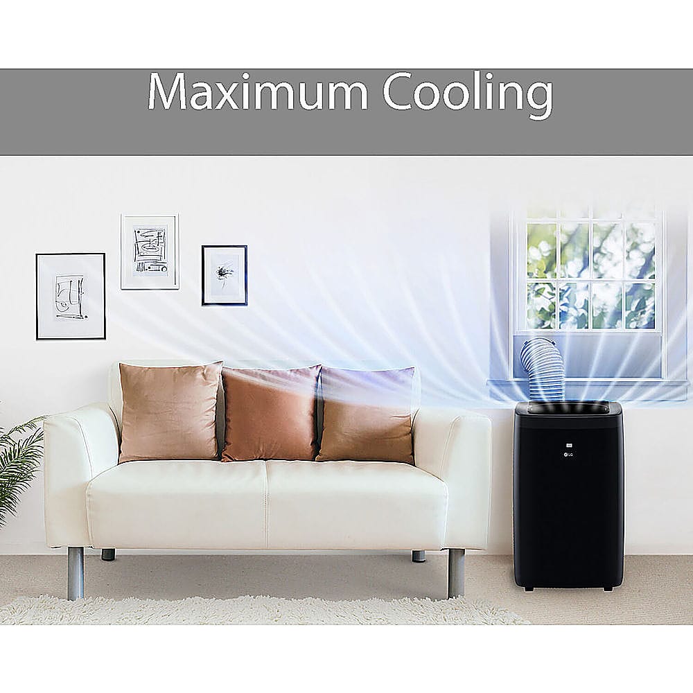 The image depicts a living room with a white couch and a black and white air conditioner. The air conditioner is positioned next to a window, and the couch is situated in front of it. The room also contains a potted plant, adding a touch of greenery to the space. The image is likely promoting the air conditioner as a solution for cooling the room during hot weather.