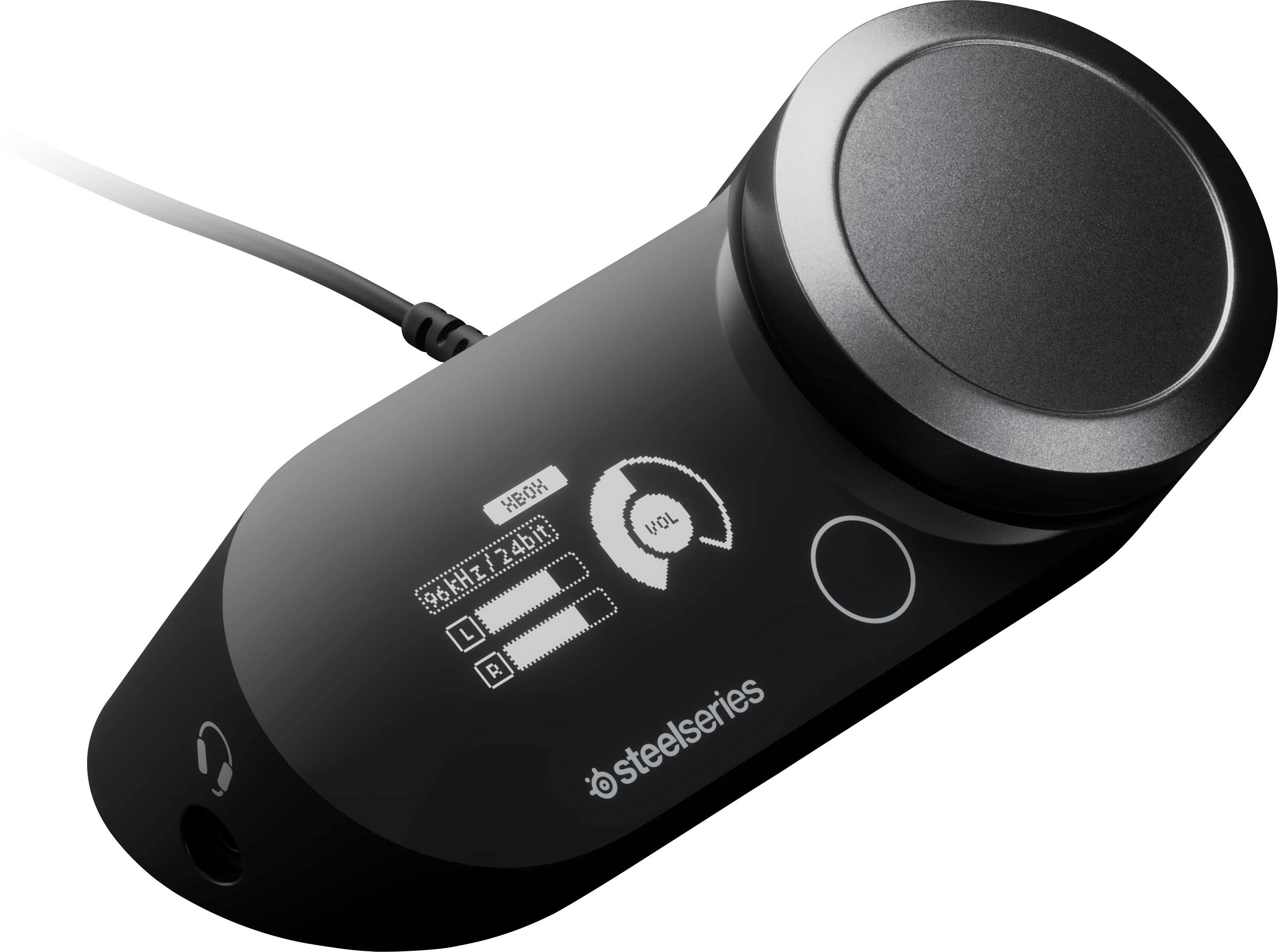 The text on the image reads "XBOX VOL 96kHz/24bit Q L = R steelseries." This text is a description of the device, which is a black Xbox controller. The controller is designed by Steelseries and is compatible with the Xbox gaming system. The controller is equipped with a 96kHz/24bit audio output, which provides high-quality audio for an immersive gaming experience.