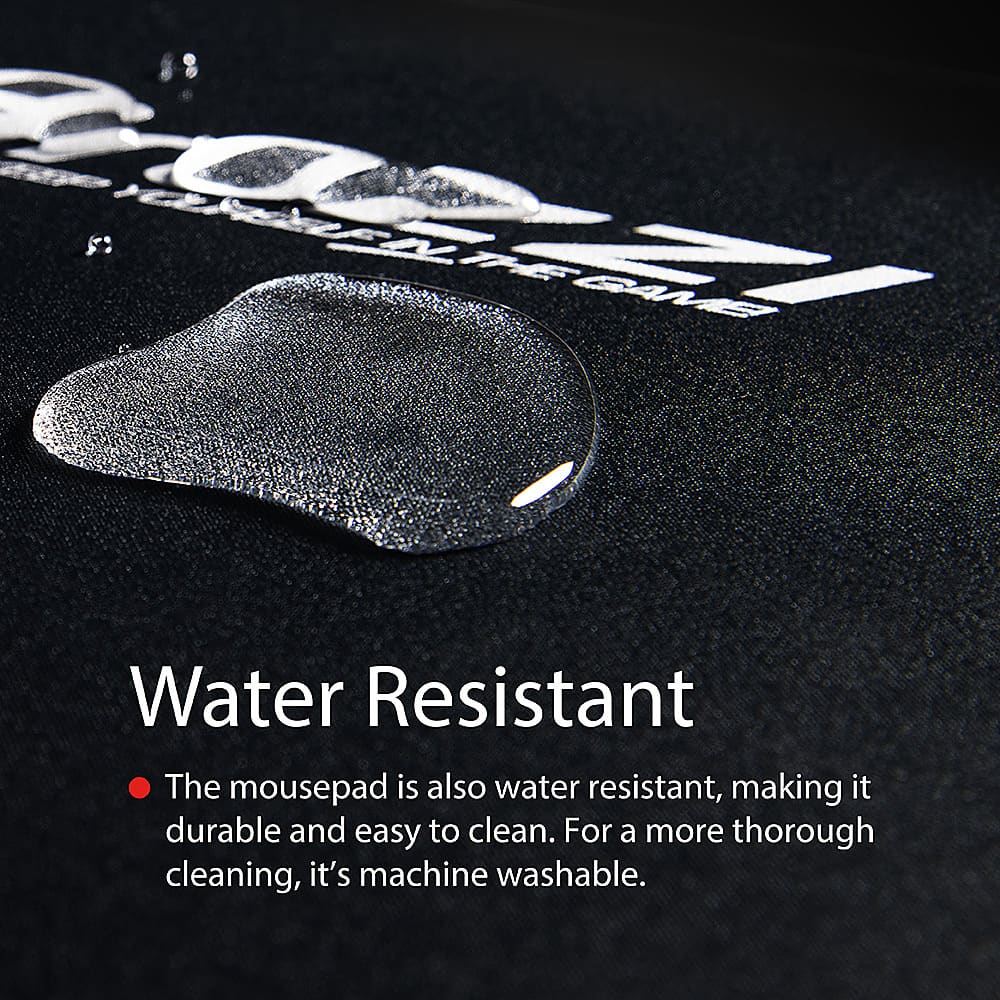 The man is sitting in a chair with a large computer monitor in front of him. He is wearing headphones and using a keyboard and mouse to play a video game. The room also has a potted plant and a vase, adding to the overall ambiance.