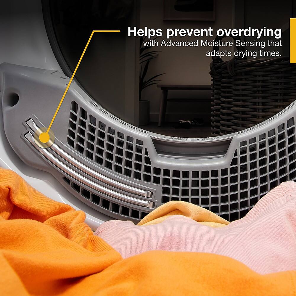 The image features a dryer with a yellow label that says "Helps prevent overdrying with Advanced Moisture Sensing that adapts drying times." The dryer is placed inside a room with a couch and a potted plant nearby.