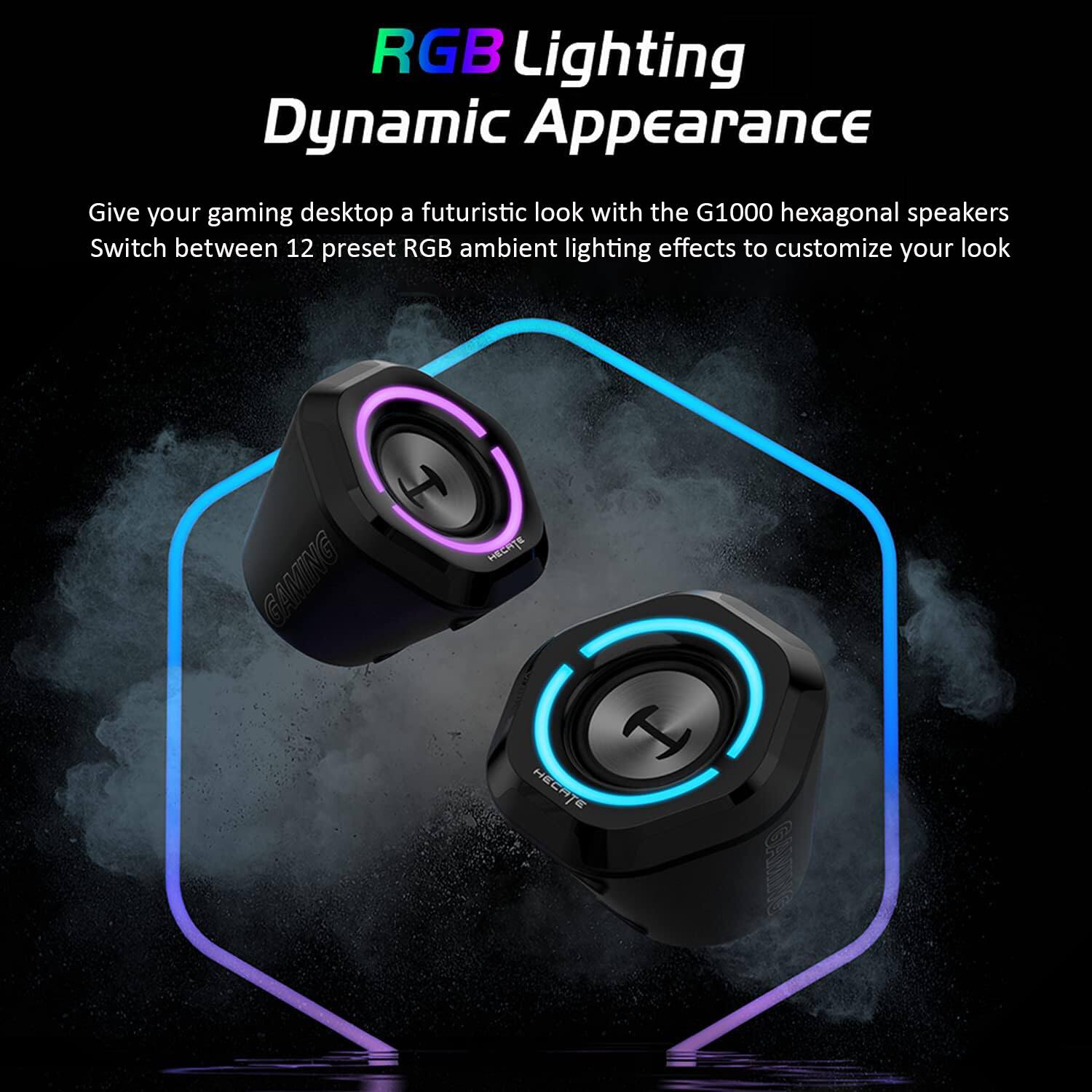 The image showcases a pair of black and purple computer speakers with RGB lighting. The speakers are designed to give a futuristic look to your gaming desktop. With the G1000 hexagonal speakers, you can switch between 12 preset RGB ambient lighting effects to customize your look. The speakers are equipped with a switch that allows you to change between different lighting effects, providing a dynamic appearance that enhances your gaming experience.