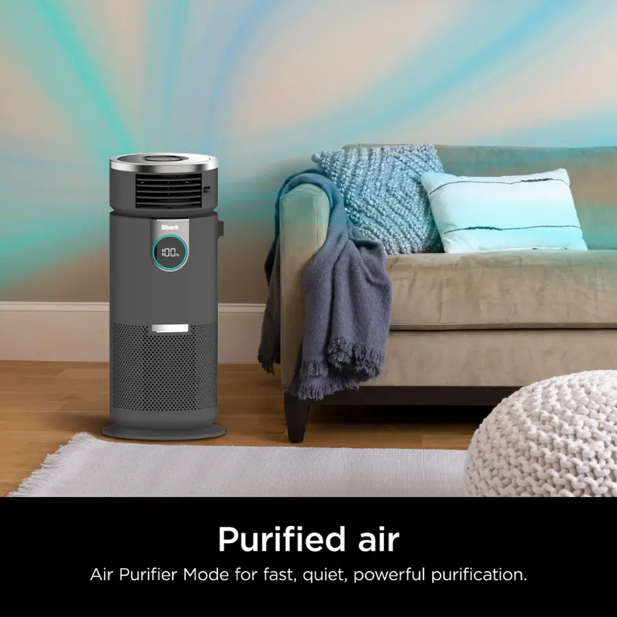 The image features a purified air air purifier with a blue and white blanket draped over the back of a couch. The air purifier is placed on the floor, and the couch is positioned in the background. The scene suggests a cozy and comfortable living space, with the air purifier providing clean and purified air for the occupants.