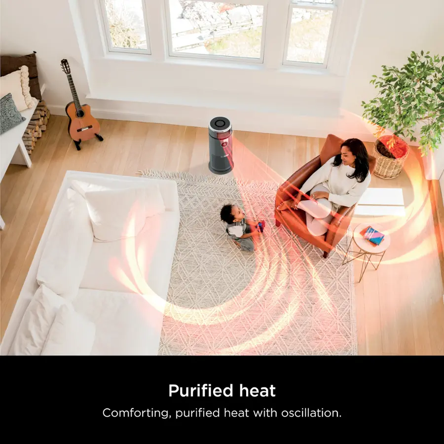 The image features a woman sitting on a chair with a child in her arms, both of them in a cozy living room setting. The room is furnished with a couch, a potted plant, and a guitar. The woman appears to be reading a book while holding the child. The scene suggests a warm and comfortable atmosphere, possibly created by a purified heat system with oscillation, which can help maintain a pleasant temperature in the room.